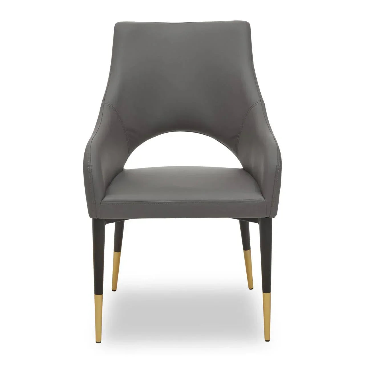 Grey dining chair with cut-out back and black legs featuring gold-tone tips, front view