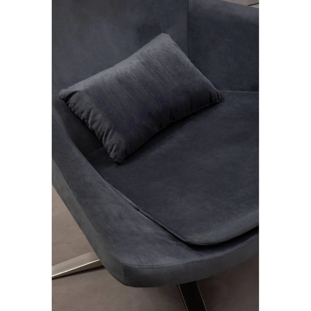Dark grey velvet armchair with matching cushion and metal leg detail, angled view