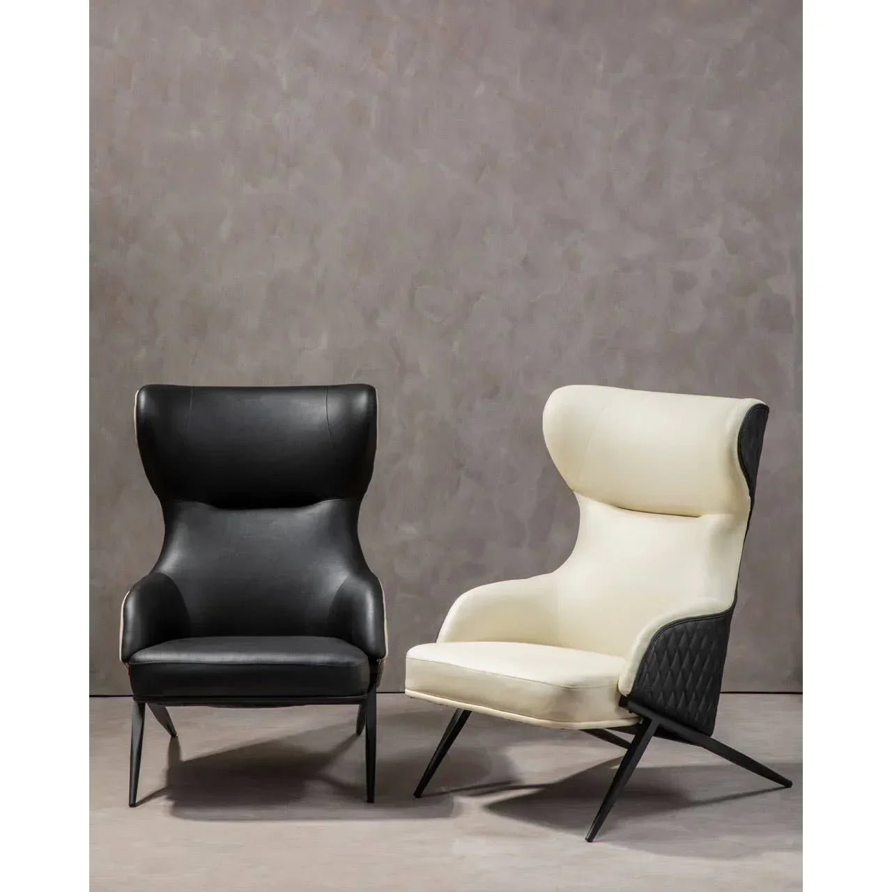 Pair of modern high back accent chairs in black and white faux leather on angled legs