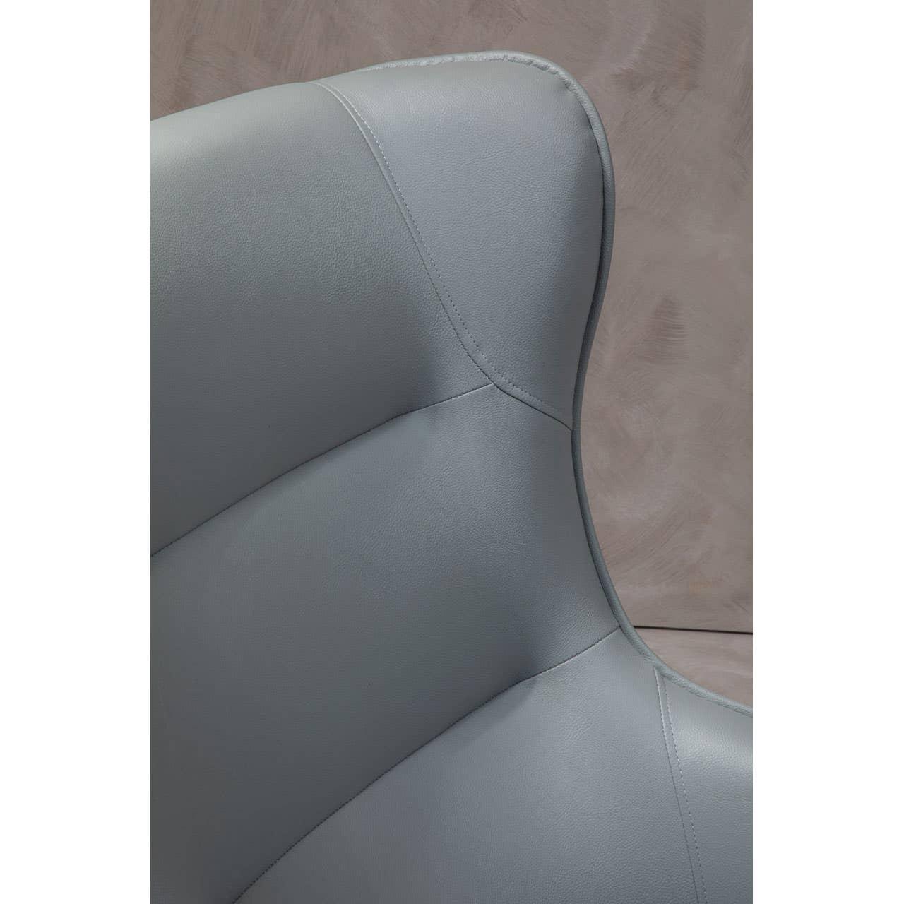 Closeup of grey faux leather chair backrest with detailed stitching