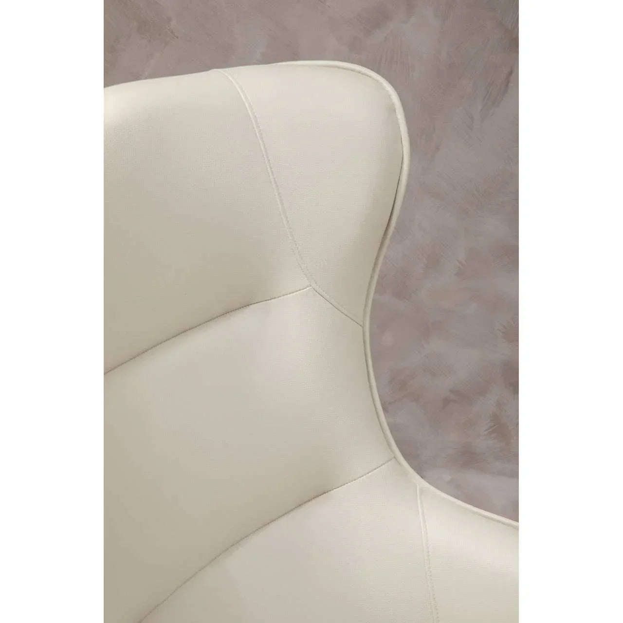 Close-up of cream leather chair backrest with curved stitching detail