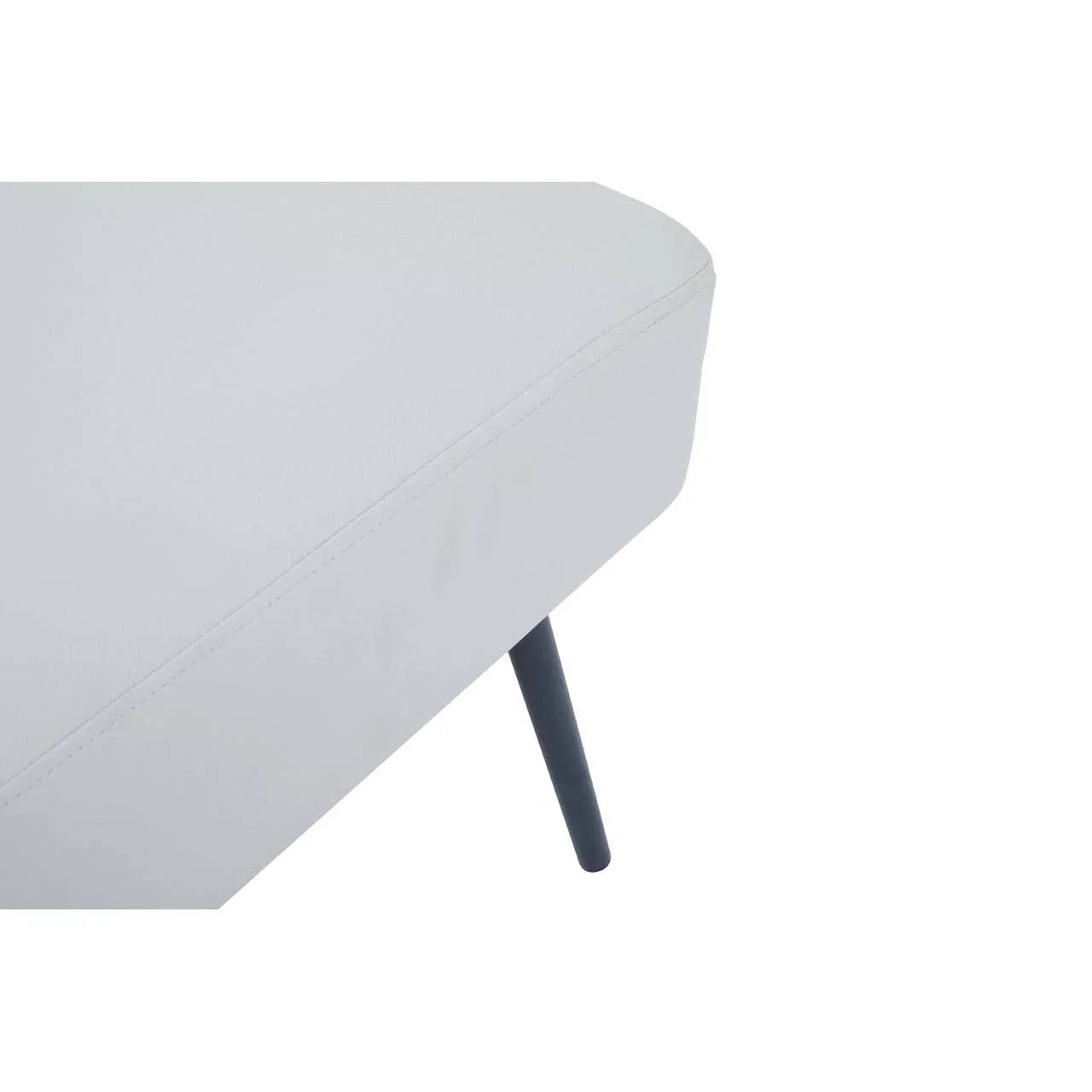 Close up of light grey sofa corner with black angled metal leg