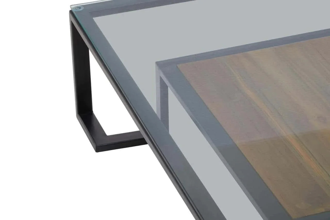 Glass top coffee table with black metal frame and wood accent detail, corner view