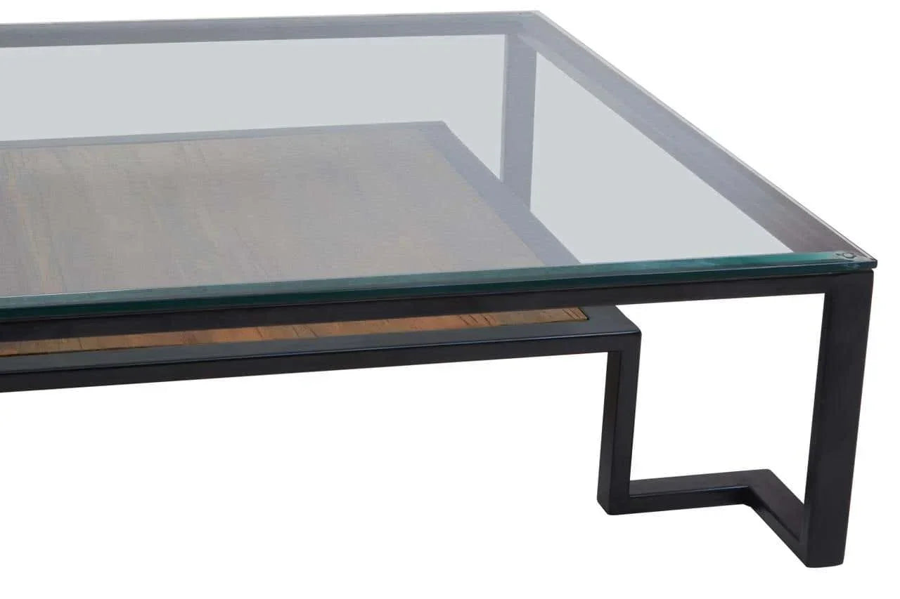 Modern glass coffee table with black metal frame and wood shelf, angled view