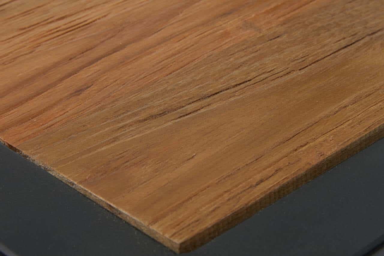 Close-up of wooden dining table top with natural grain and black metal edge