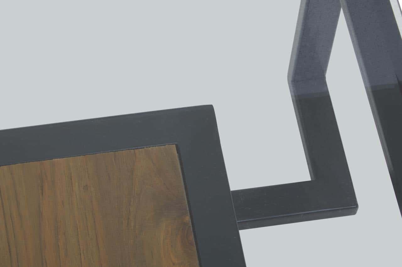 Closeup of modern coffee table with black metal frame and wood top detail