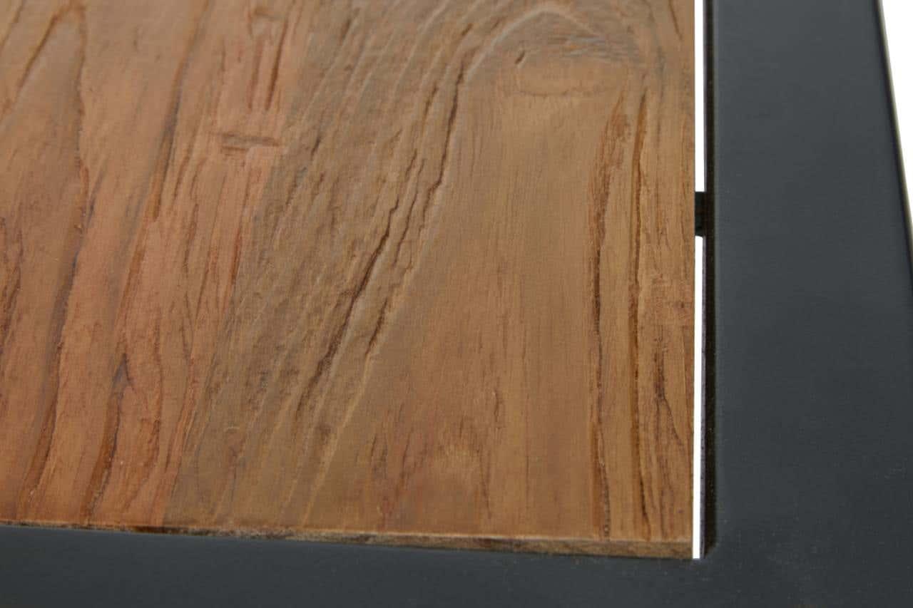 Closeup of wooden tabletop with visible grain and black metal frame edge