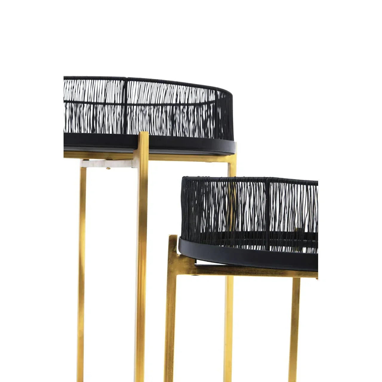 Set of two black metal wire side tables with gold legs, close-up view