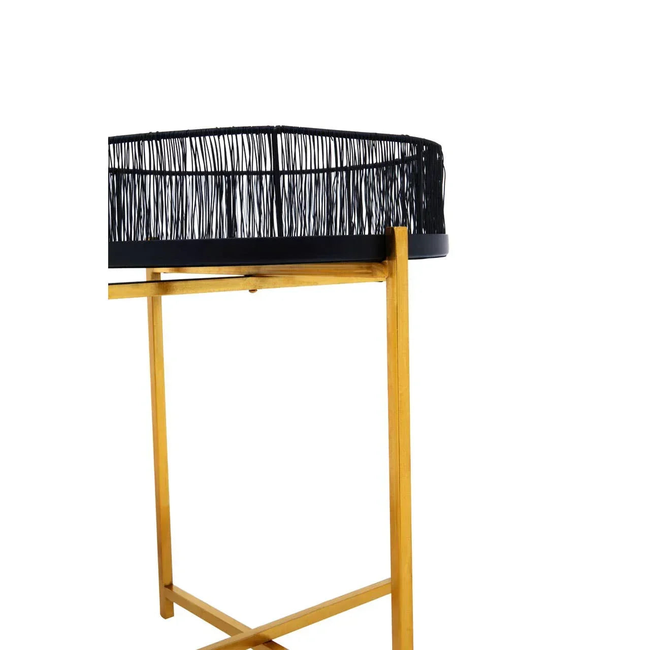 Black rattan side table with gold wooden legs, close-up on woven edge and frame