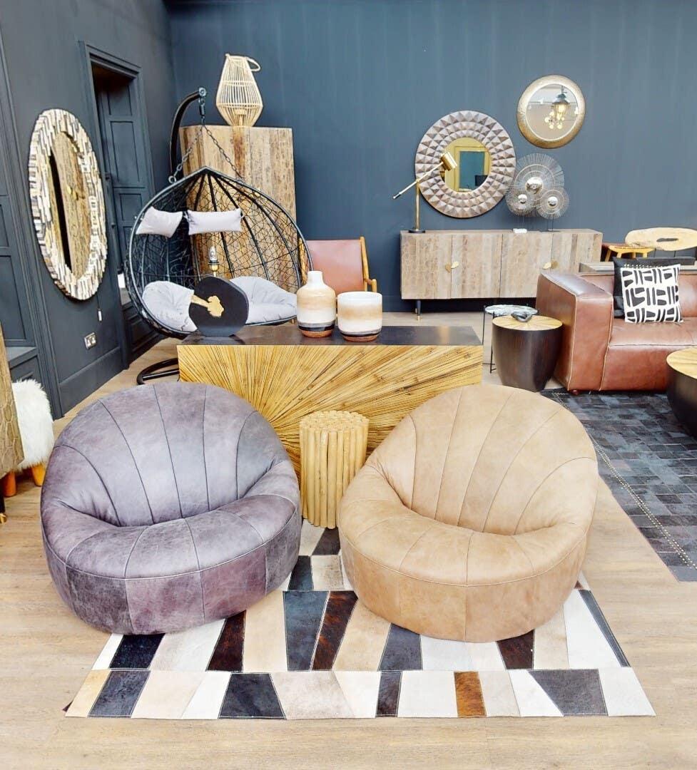 Contemporary leather accent chairs and modern furniture in stylish showroom setting