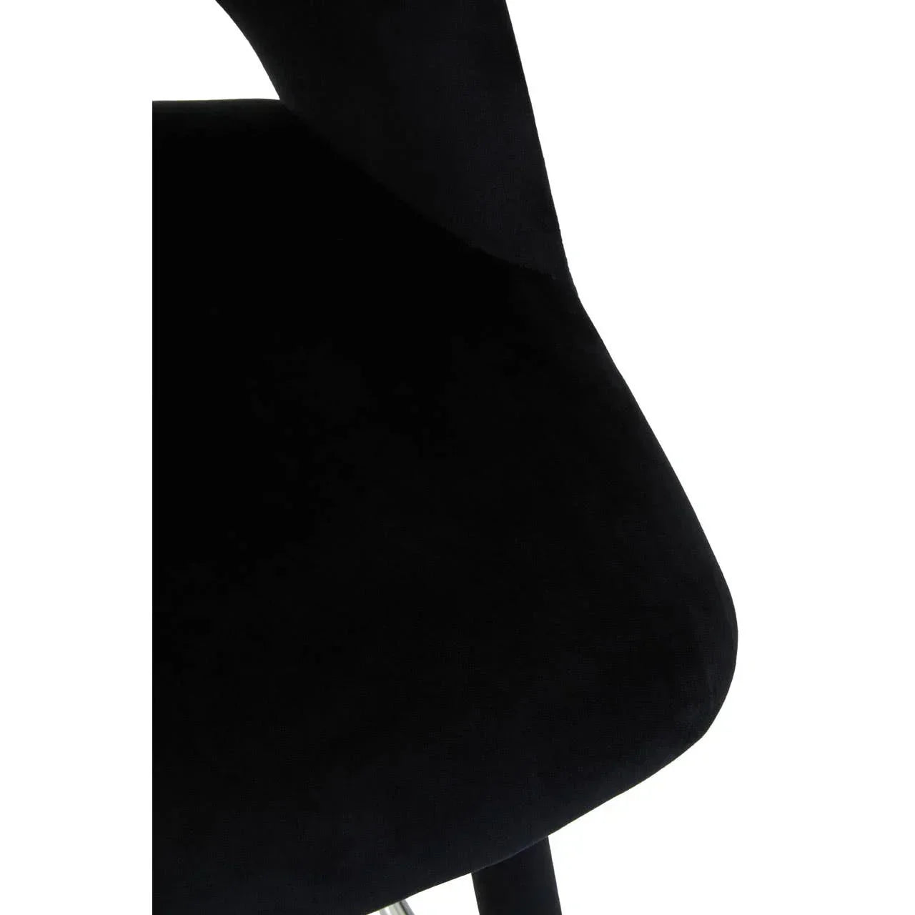 Closeup of black velvet dining chair seat and leg