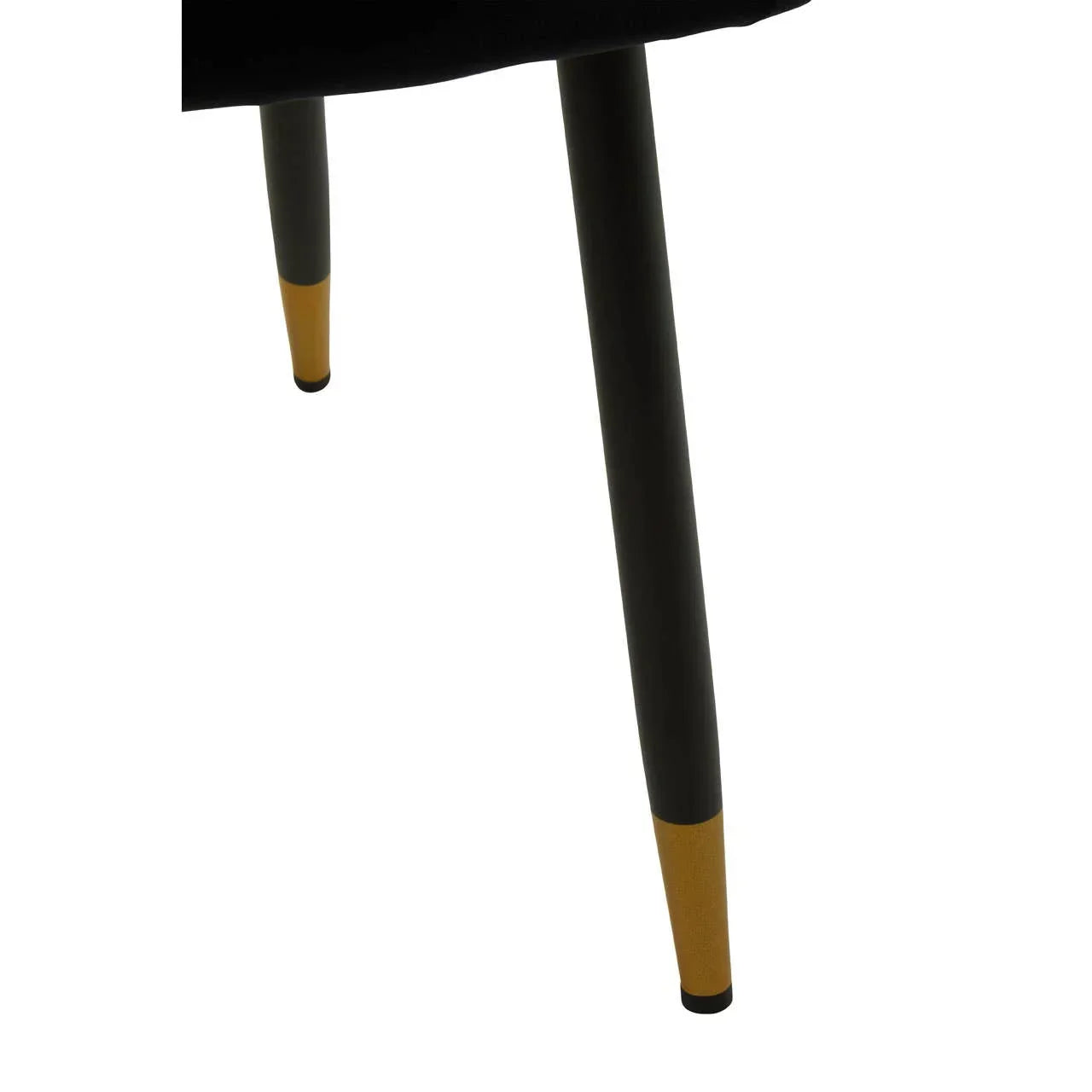 Black chair legs with gold metal tips, closeup of modern furniture detail