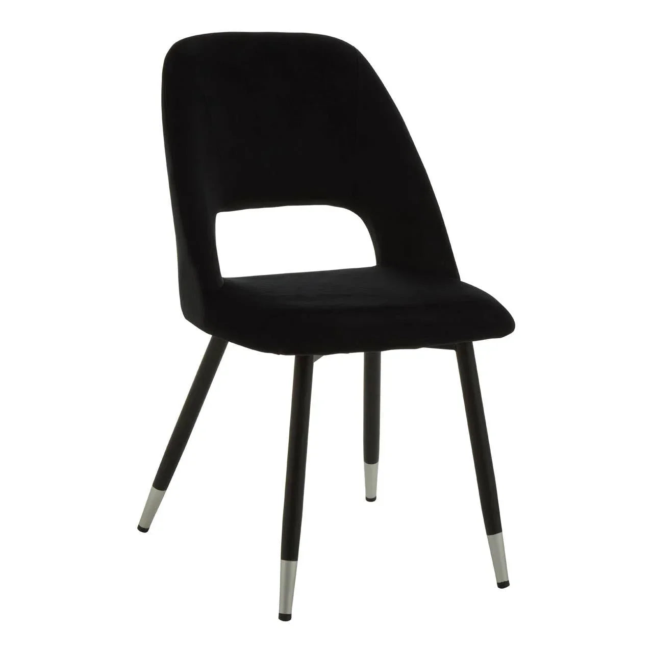 Black velvet dining chair with cutout back and metal legs, front angle view