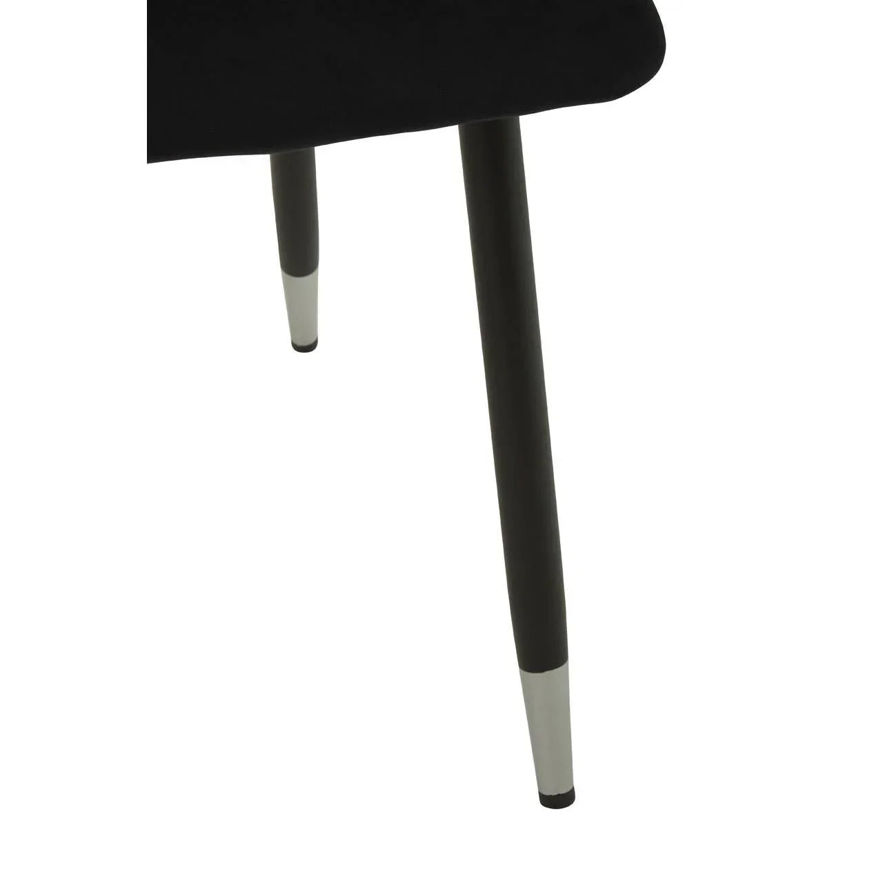 Black dining chair with tapered metal legs and chrome caps, close-up of leg detail