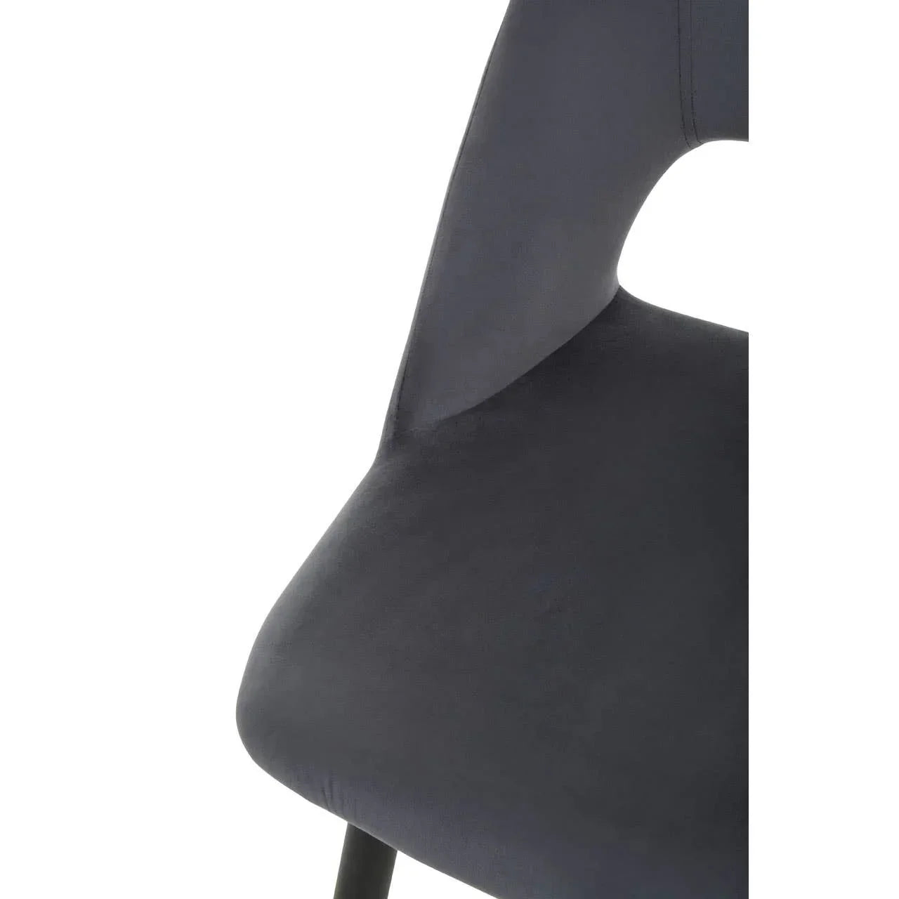 Close-up of dark grey velvet dining chair seat with black metal leg