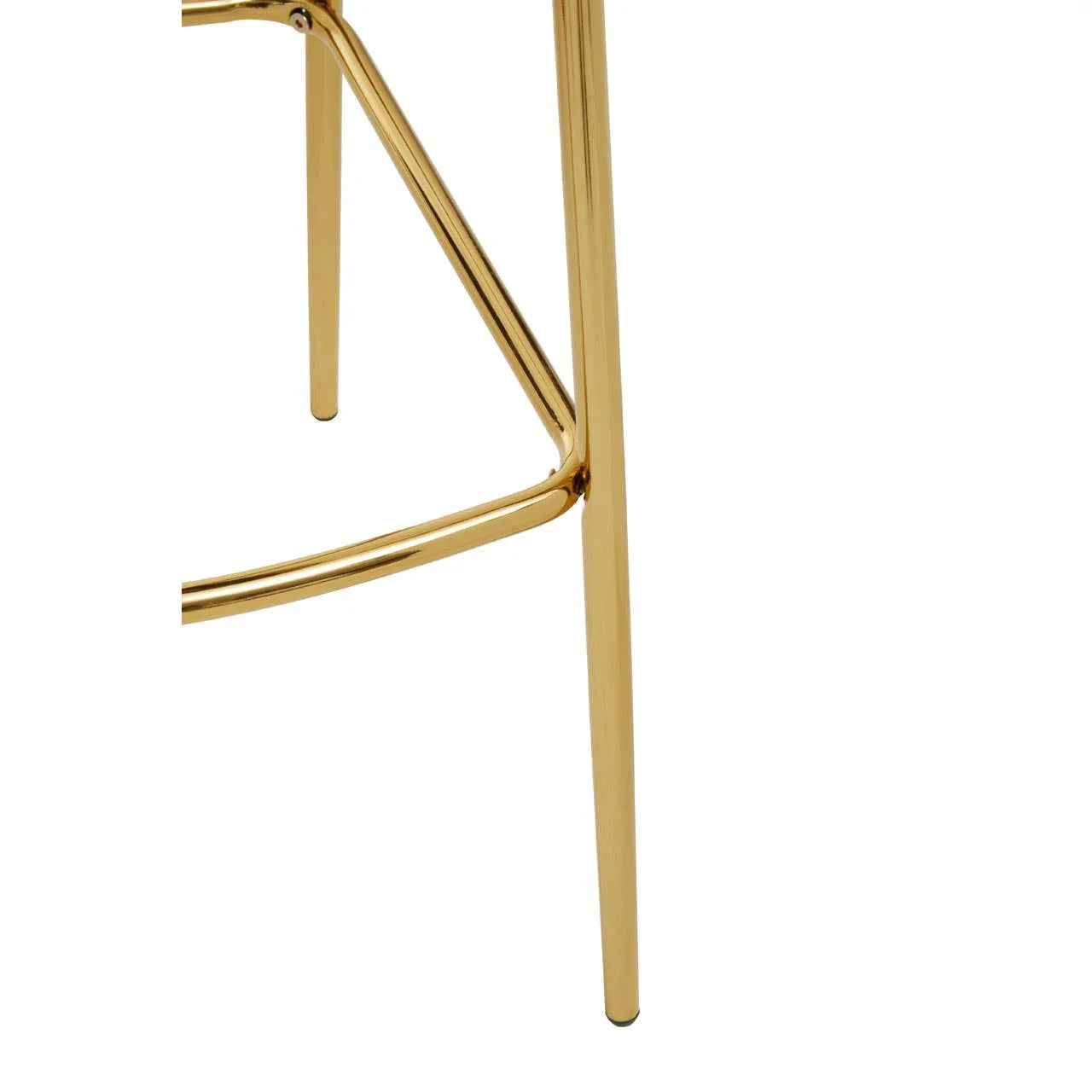 Gold metal stool legs with connecting support bar, close-up furniture detail