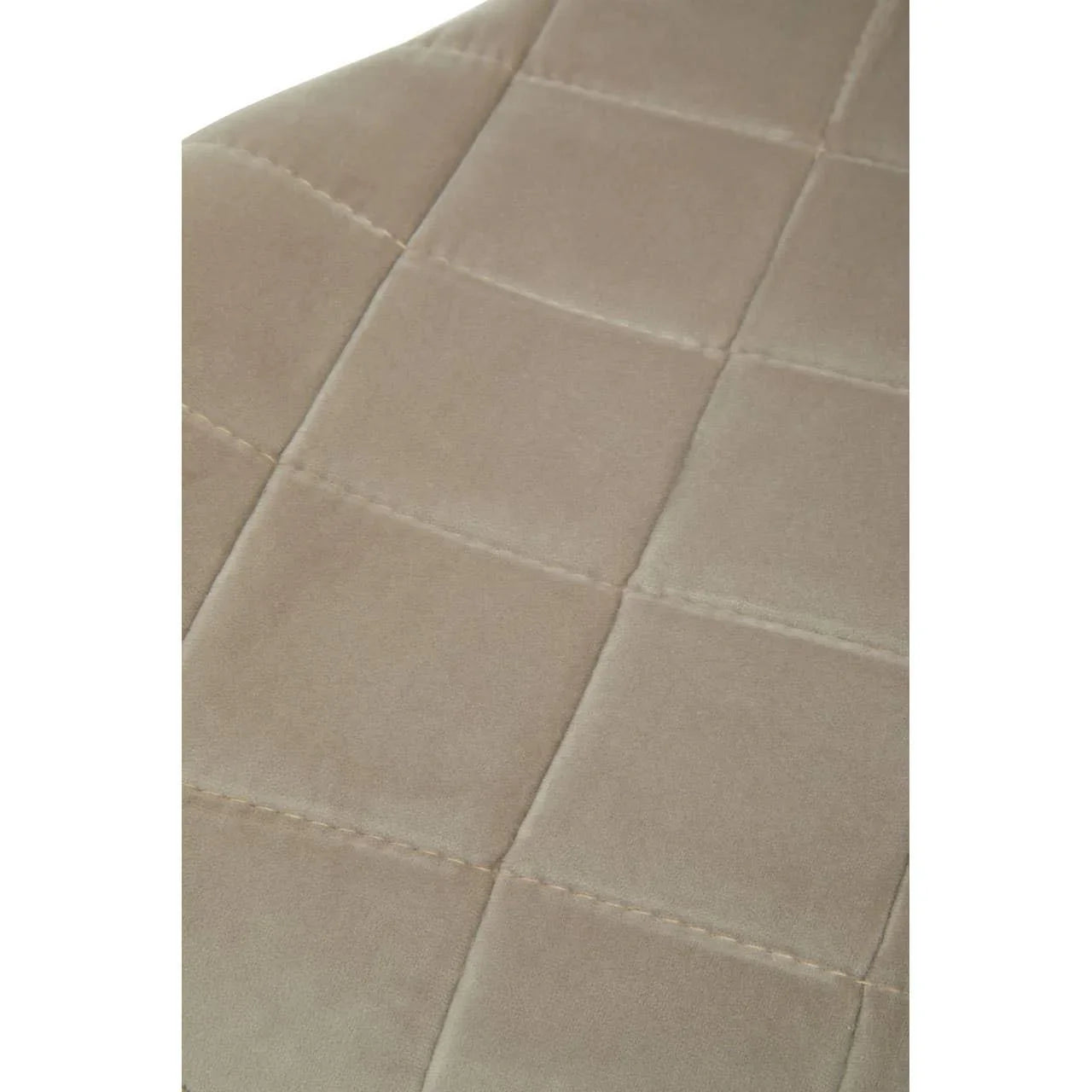 Beige velvet sofa upholstery with stitched square pattern, close-up view