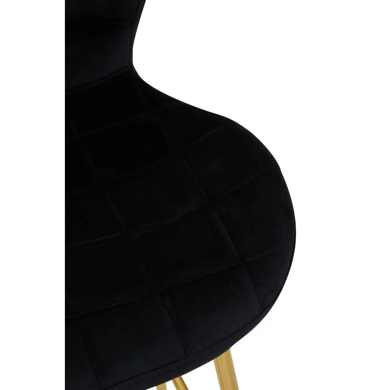 Close view of black velvet dining chair seat with gold metal legs
