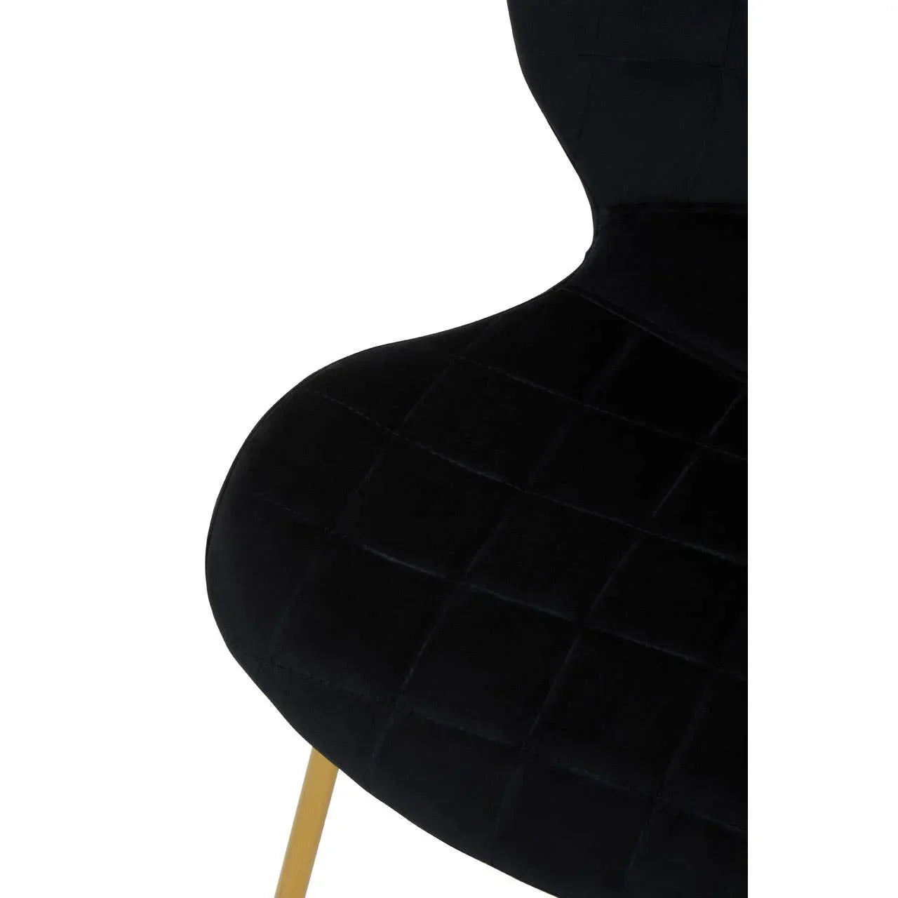 Black velvet dining chair with gold metal leg and quilted seat detail, closeup view