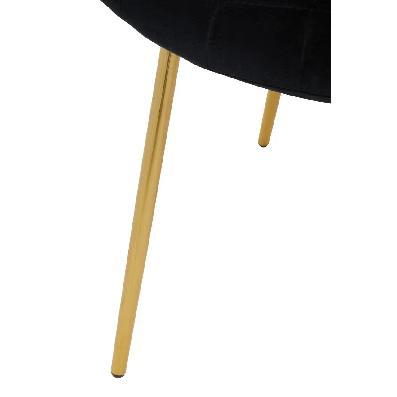 Black upholstered chair with gold metal legs close up