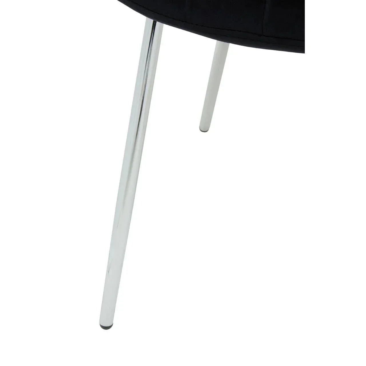Chrome metal chair legs with black upholstered seat, close-up side angle