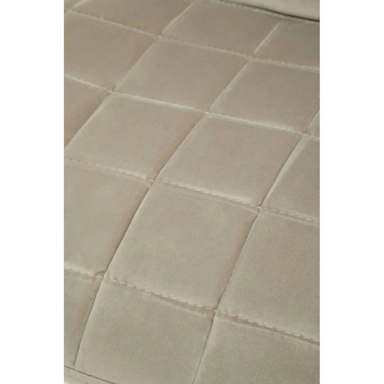 Beige velvet sofa cushion with square stitched detail, close-up view