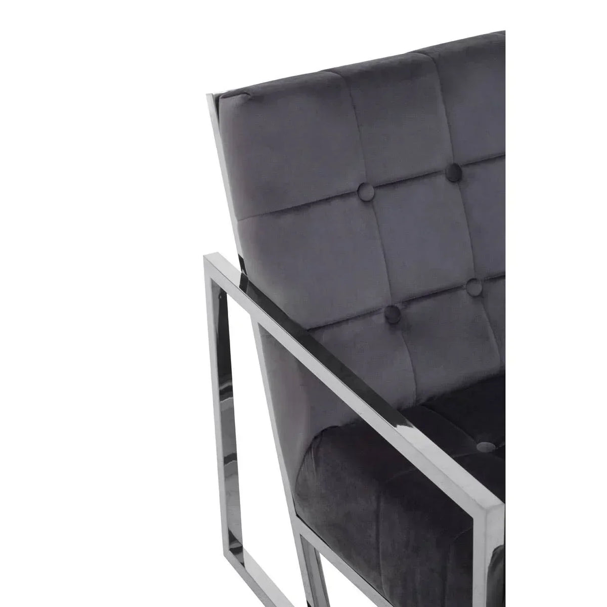 Closeup of velvet armchair with chrome frame and button tufted backrest