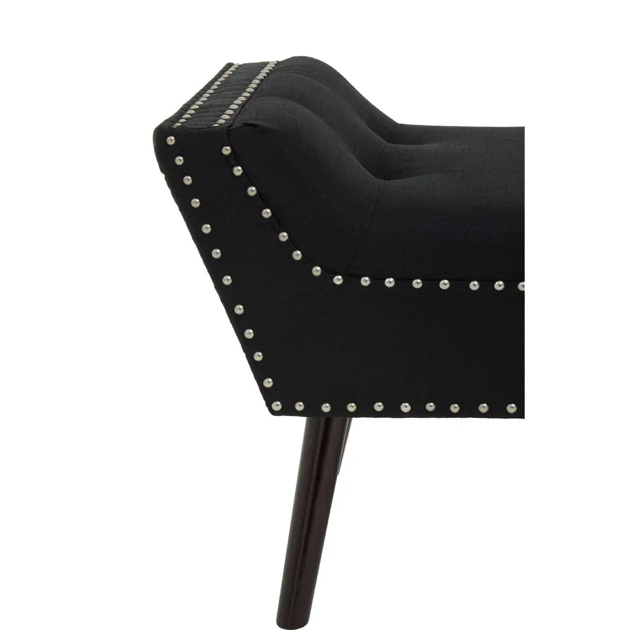 Black upholstered bench with silver stud detailing and dark wood leg, side view