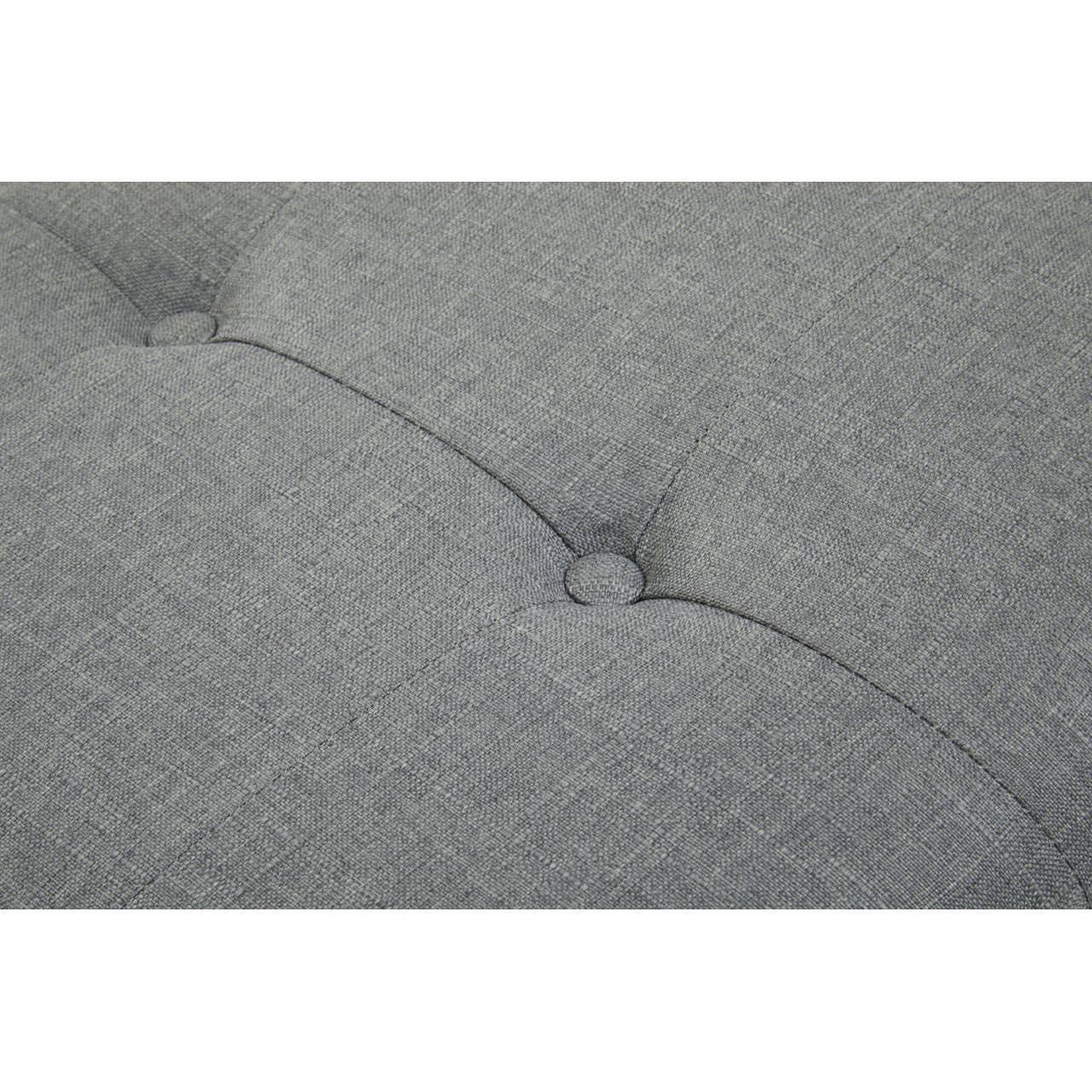 Grey fabric sofa upholstery with button tufting detail close-up