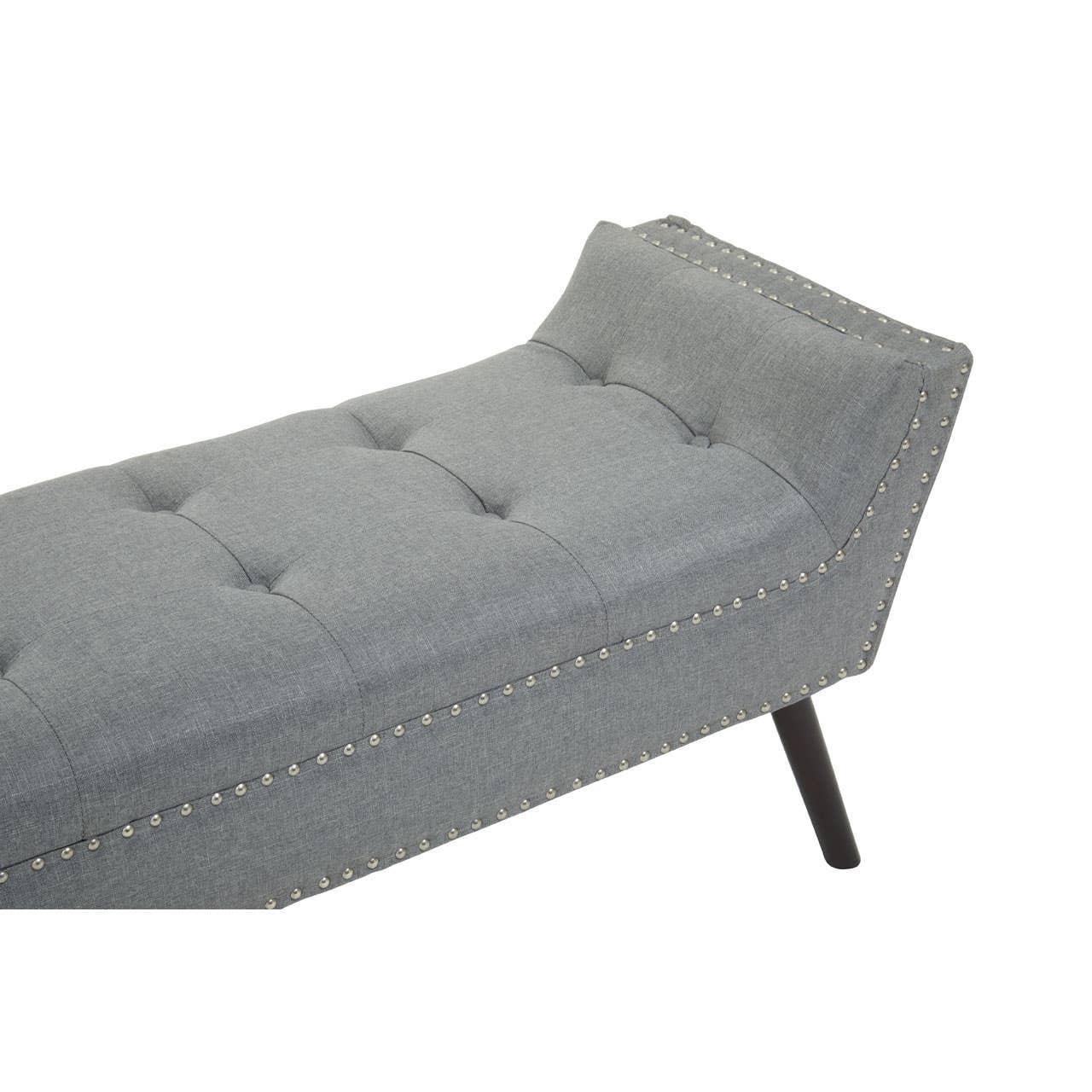 Grey upholstered bench with tufted seat, nailhead trim and angled wooden legs