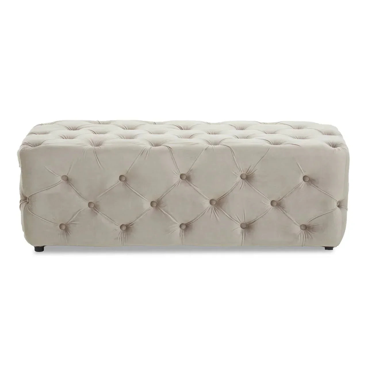 Beige velvet ottoman bench with deep button tufting and low black feet