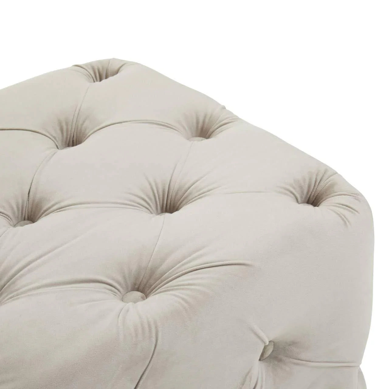 Close-up of beige tufted ottoman upholstery and button details