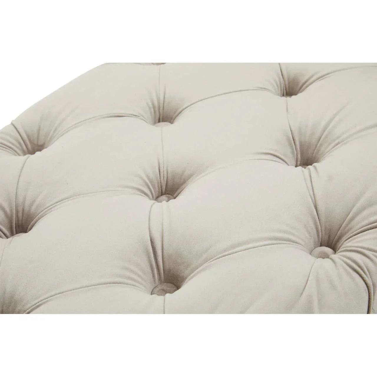 Closeup of beige tufted sofa upholstery with button details