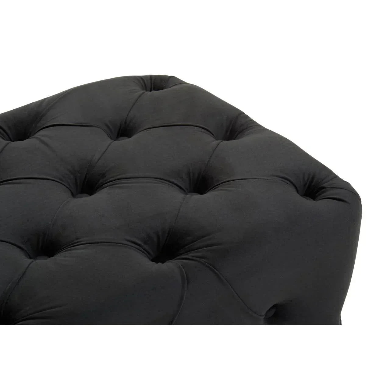 Close-up of black tufted ottoman upholstery with button detailing