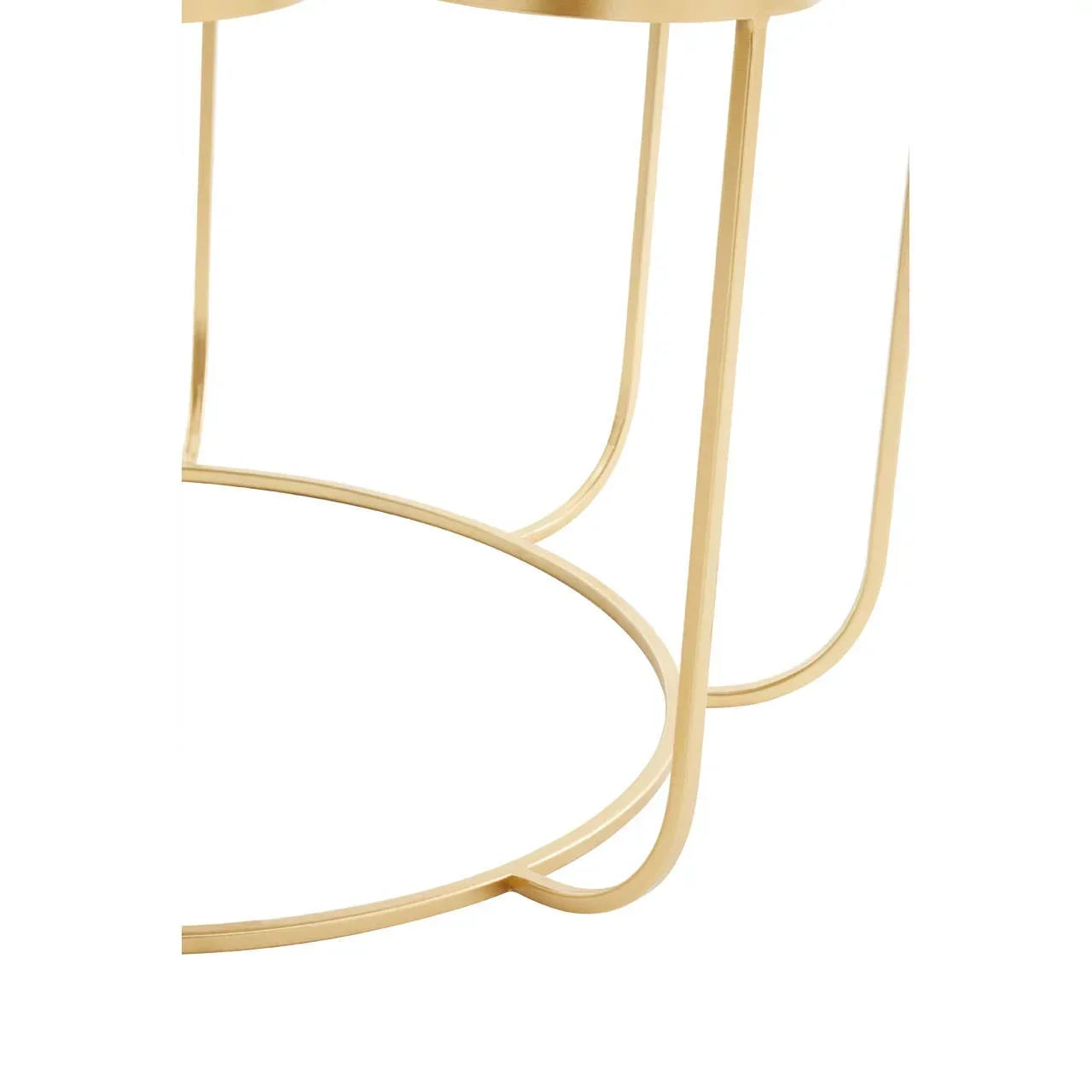 Closeup of gold metal side table frame with circular base