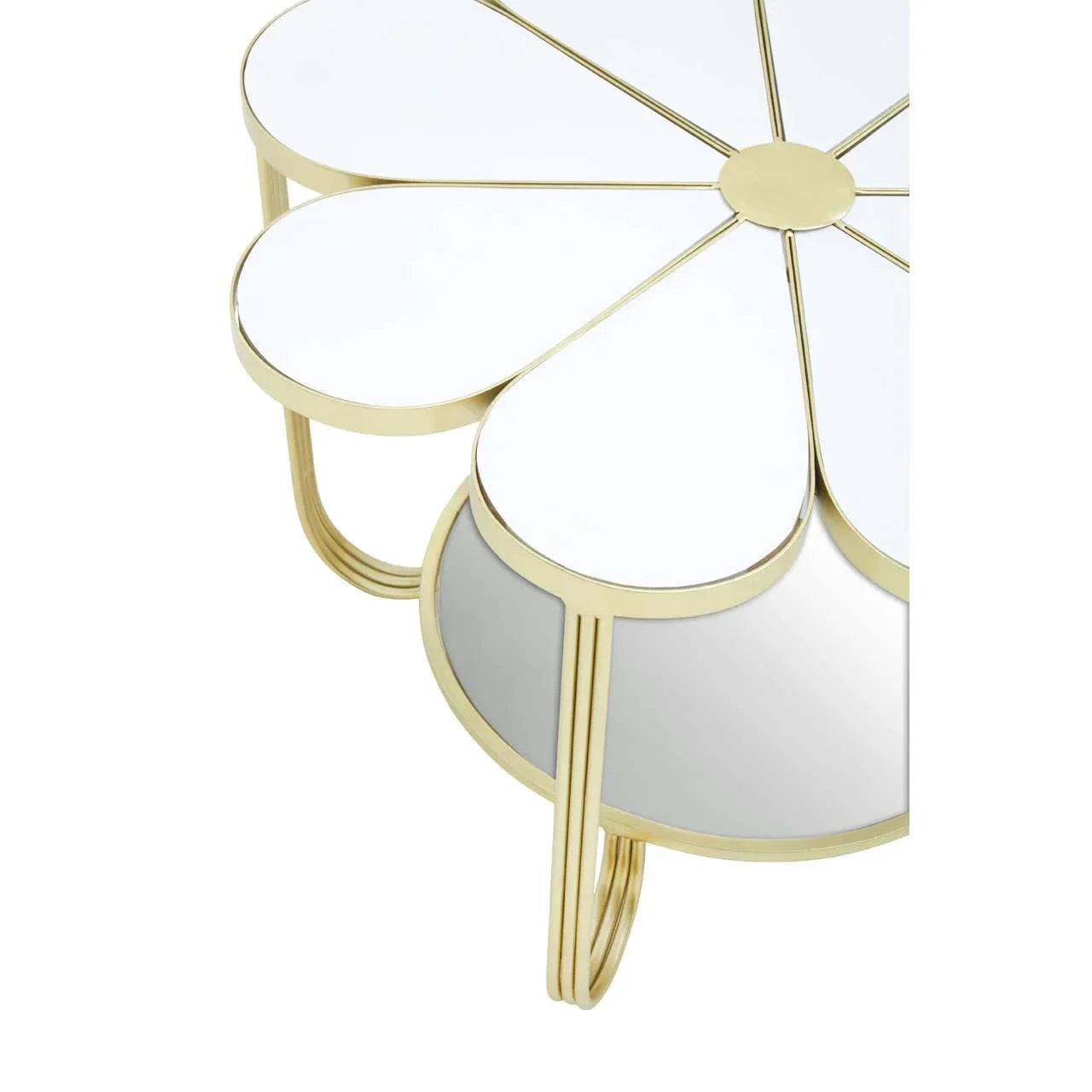 Gold metal coffee table with mirrored daisy petal top and curved legs, side view
