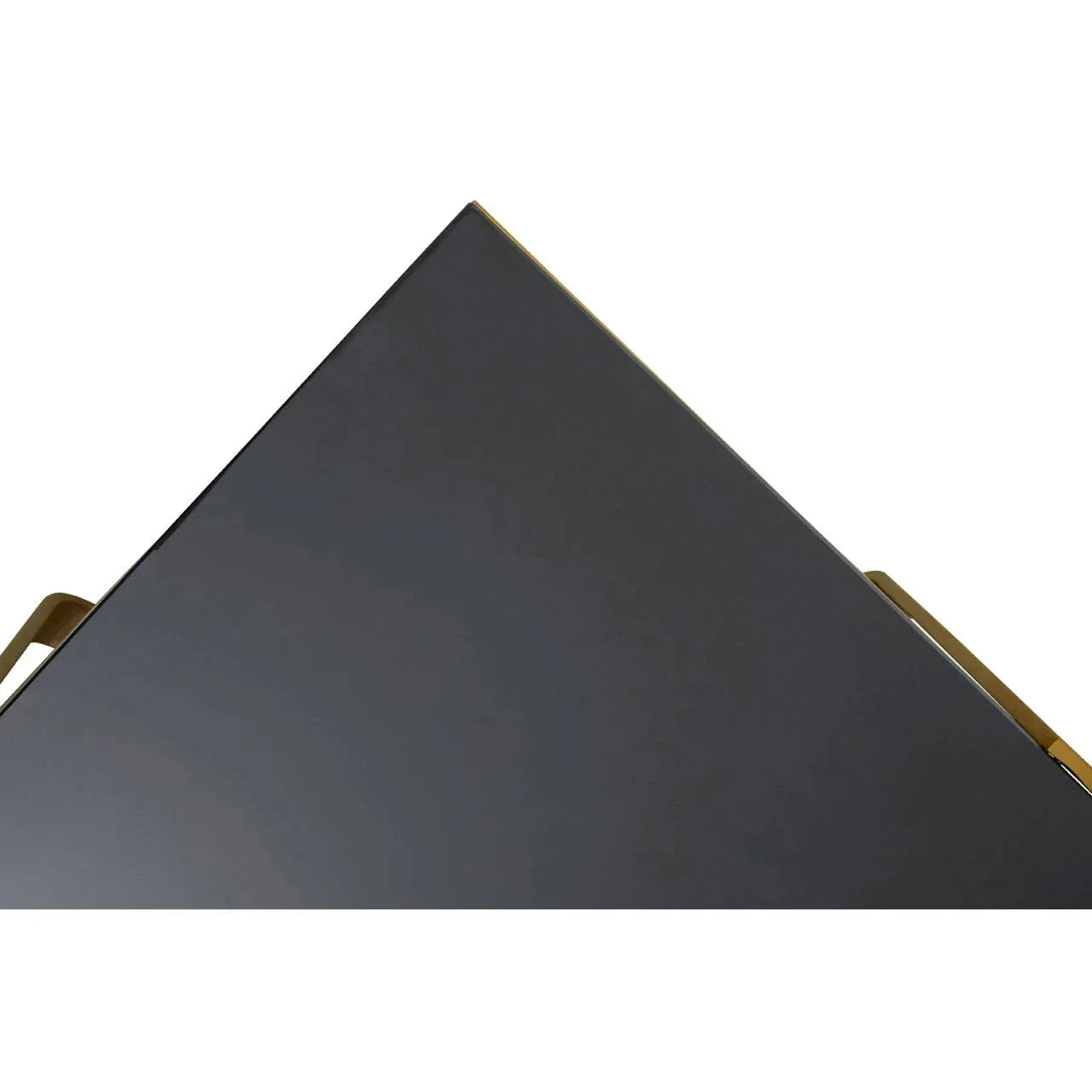 Closeup of black glass table top with gold metal edge and handle