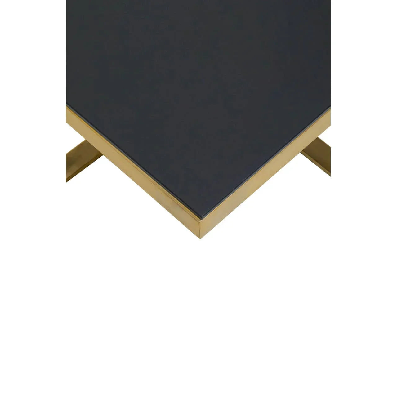 Modern black glass coffee table with gold metal edge and crossed legs, angled corner view