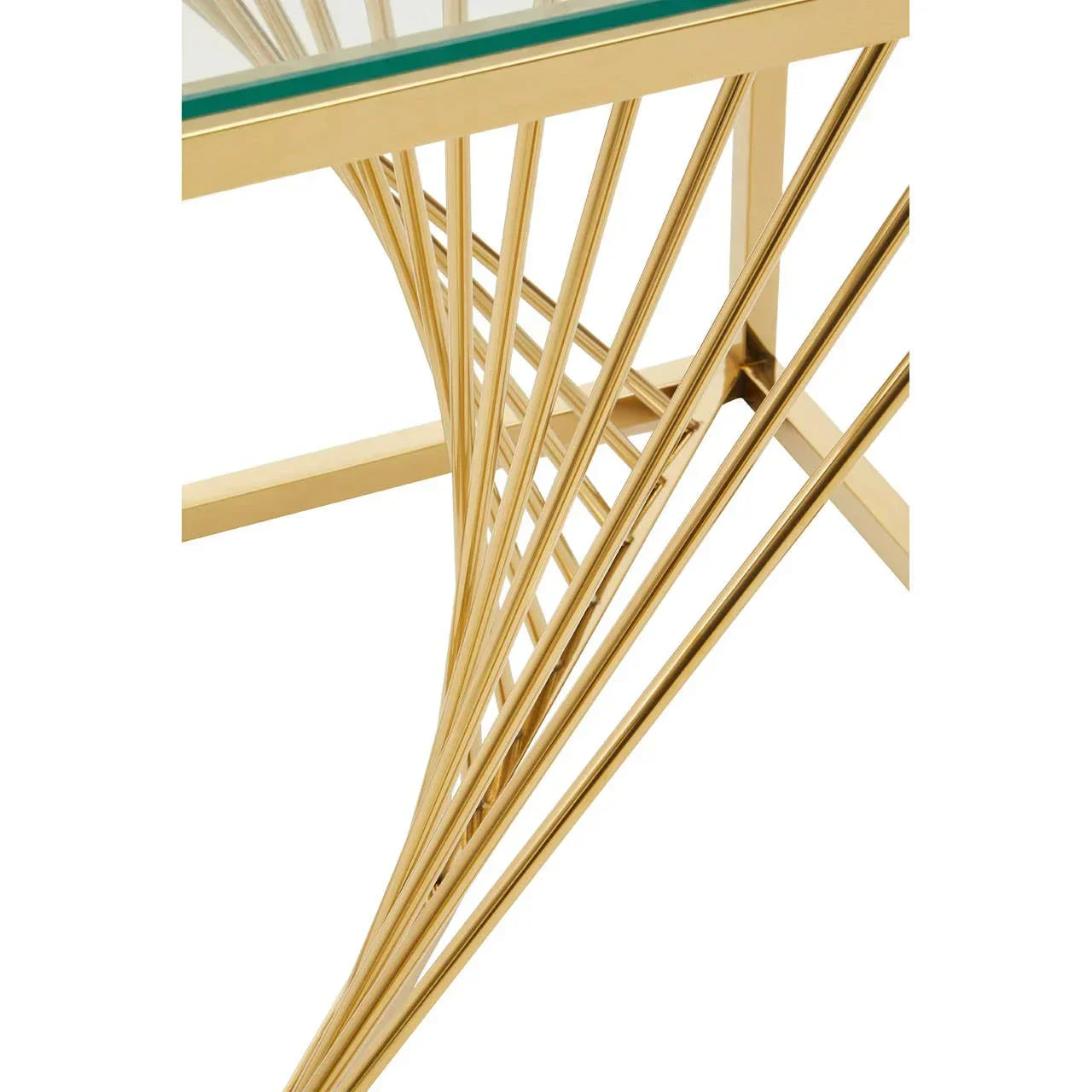 Gold metal dining table base with glass top viewed from a close angle