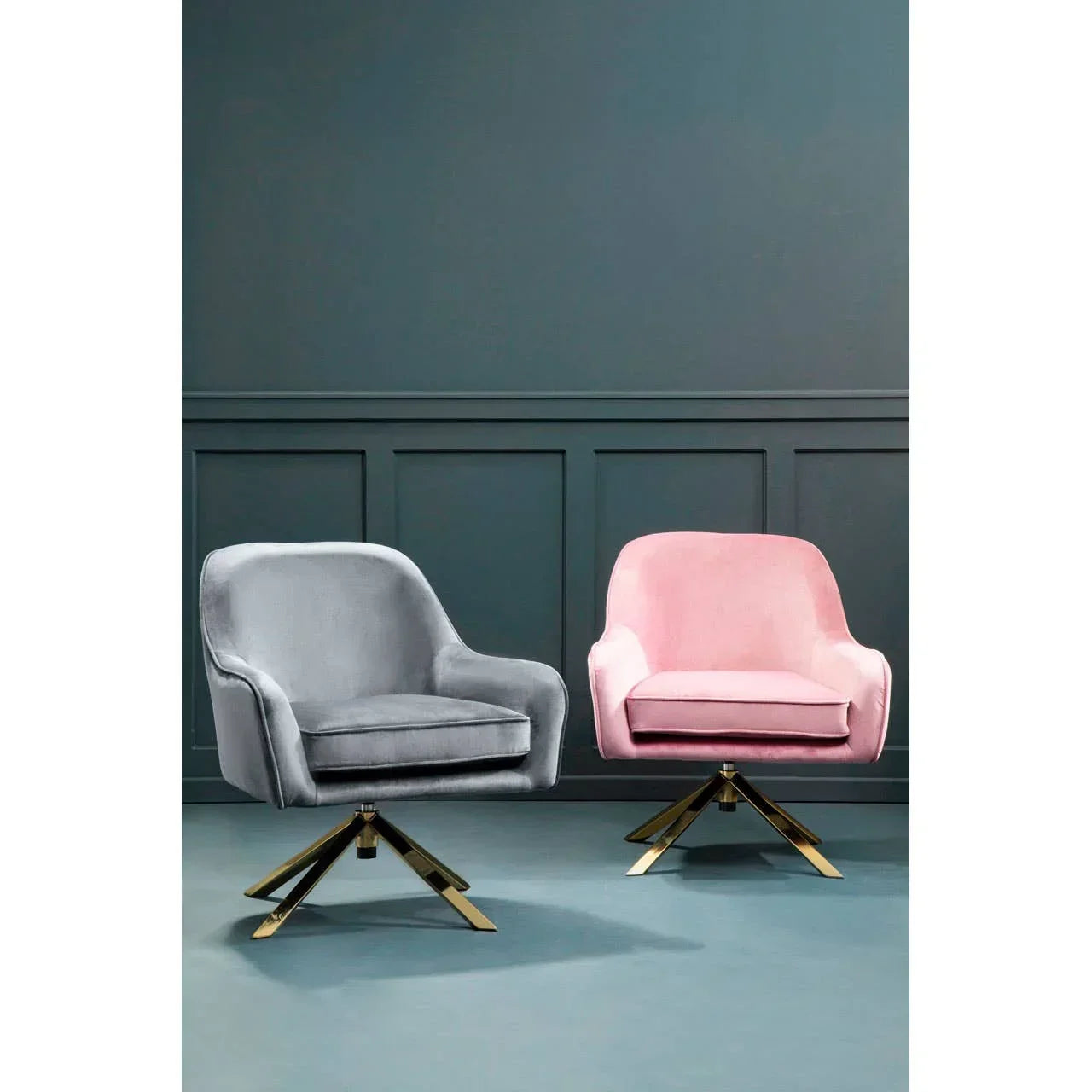 Grey and pink velvet armchairs with gold swivel bases in modern interior setting