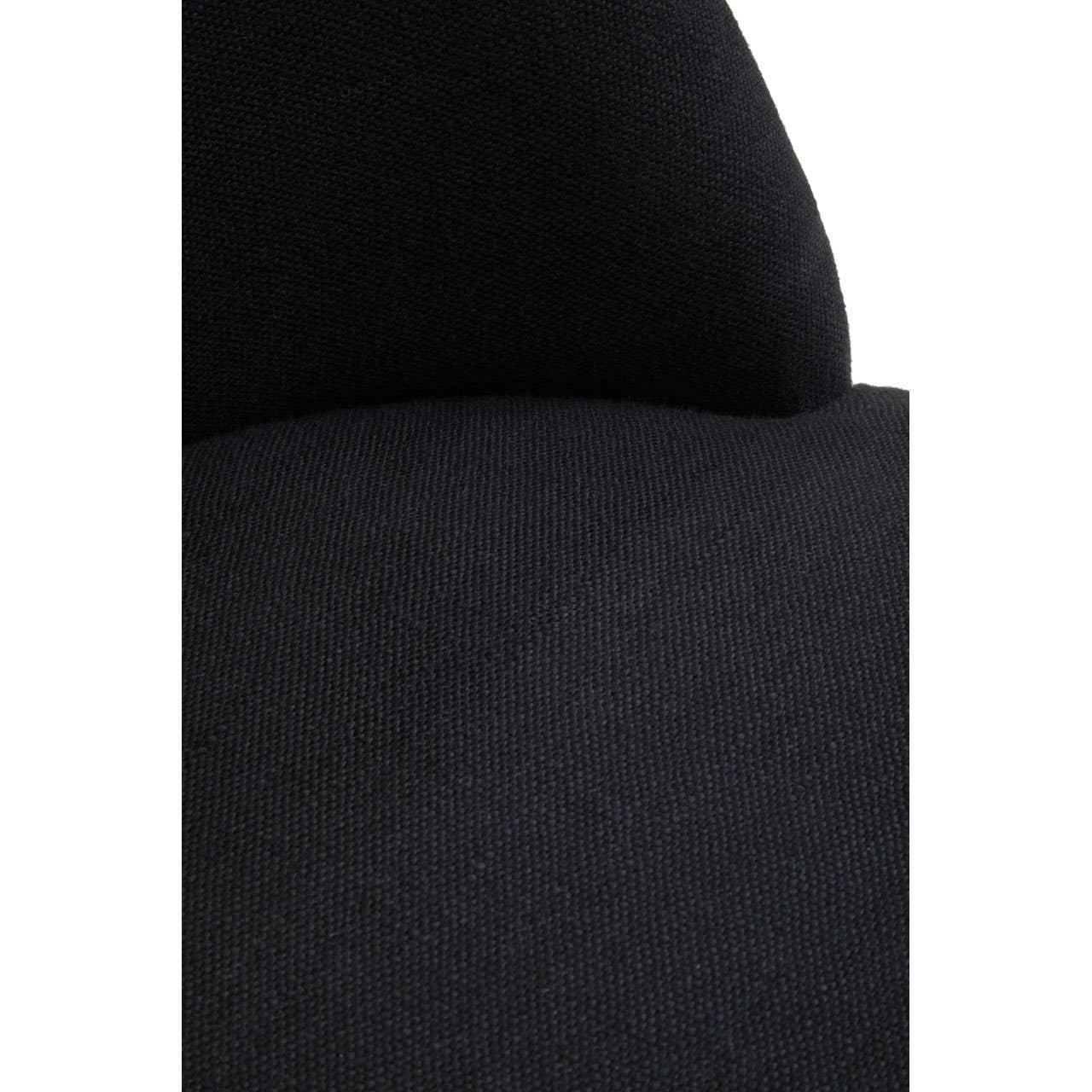 Close view of black fabric accent chair upholstery with curved backrest