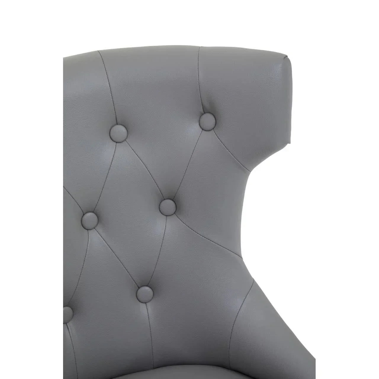 Grey leather dining chair with button-tufted backrest detail, close-up view