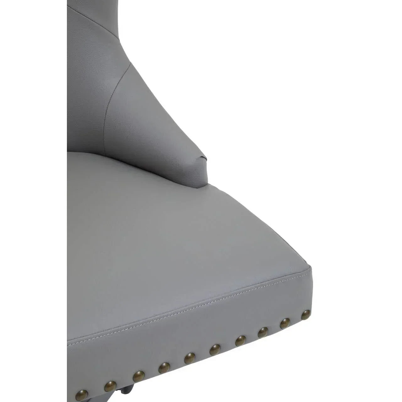 Close-up of grey leather chair seat with brass stud detailing