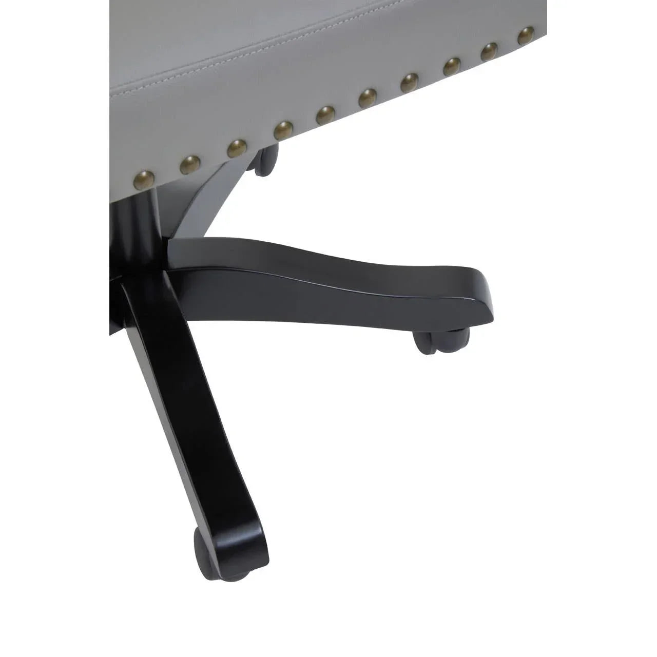 Detail of office chair base with black legs, brass stud accents and swivel casters