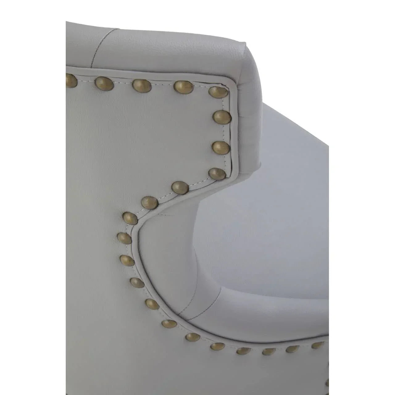 Close-up of grey leather chair with brass stud detailing on the backrest