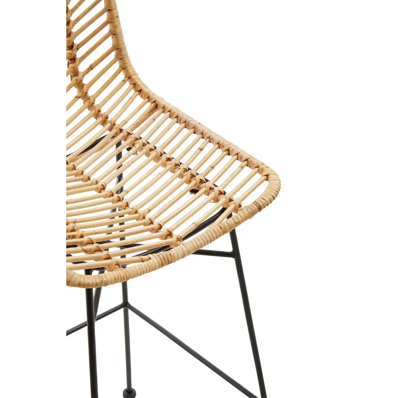 Natural rattan dining chair with black metal legs, partial close-up view
