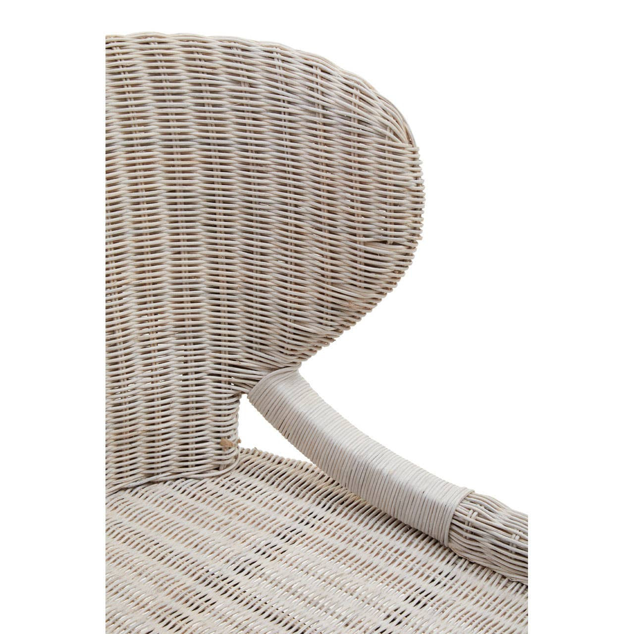 Close-up view of the Manado Wicker Chair showcasing its curved backrest and woven pattern in neutral tones, with a smooth, light-colored armrest visible on the side