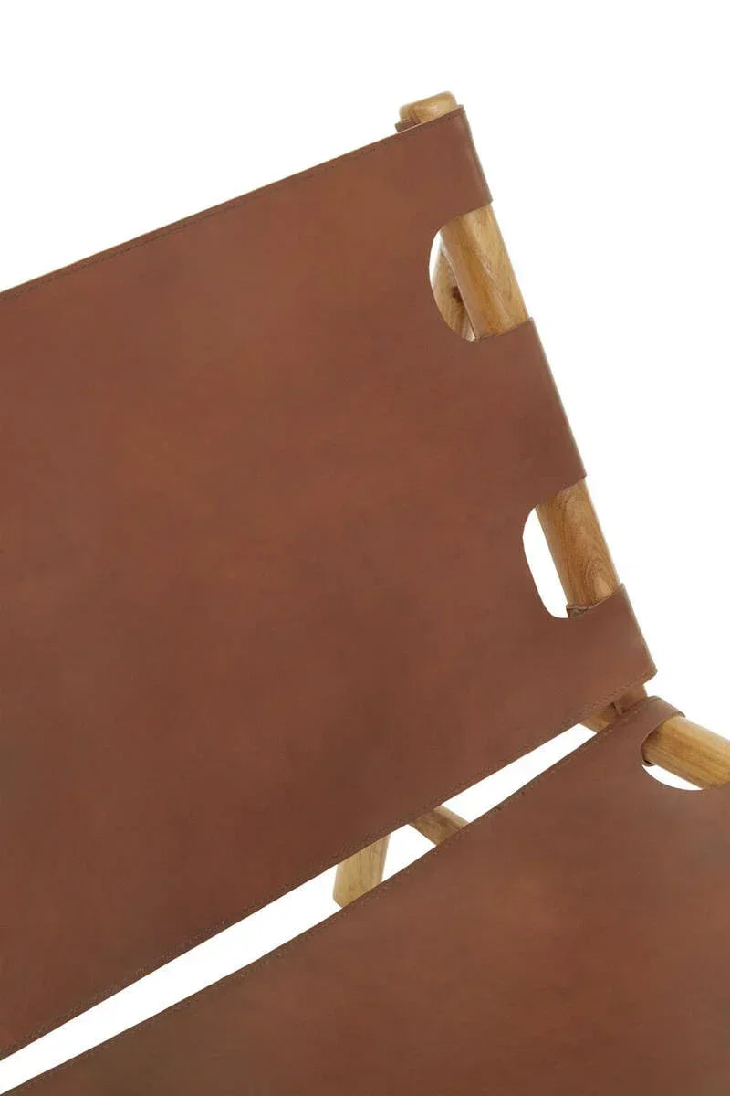 Closeup of tan leather chair seat and backrest with light wood frame