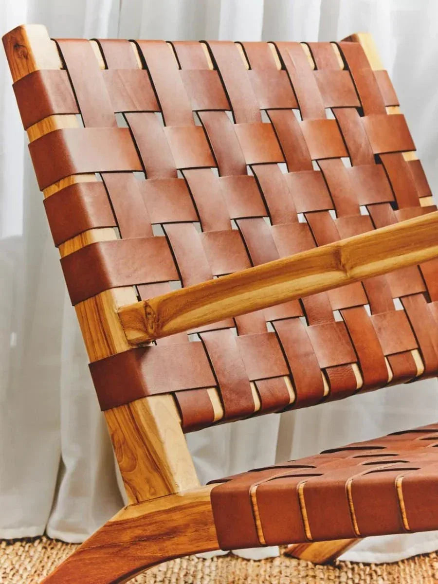 Brown leather woven lounge chair with wooden frame and natural finish, close-up view