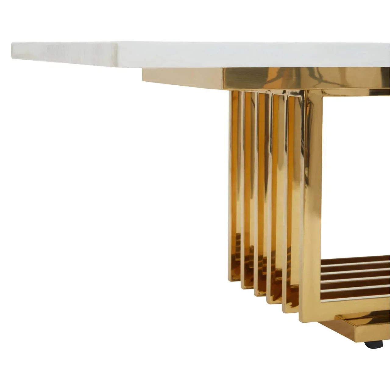 Modern dining table with white marble top and gold metal base, close-up side angle